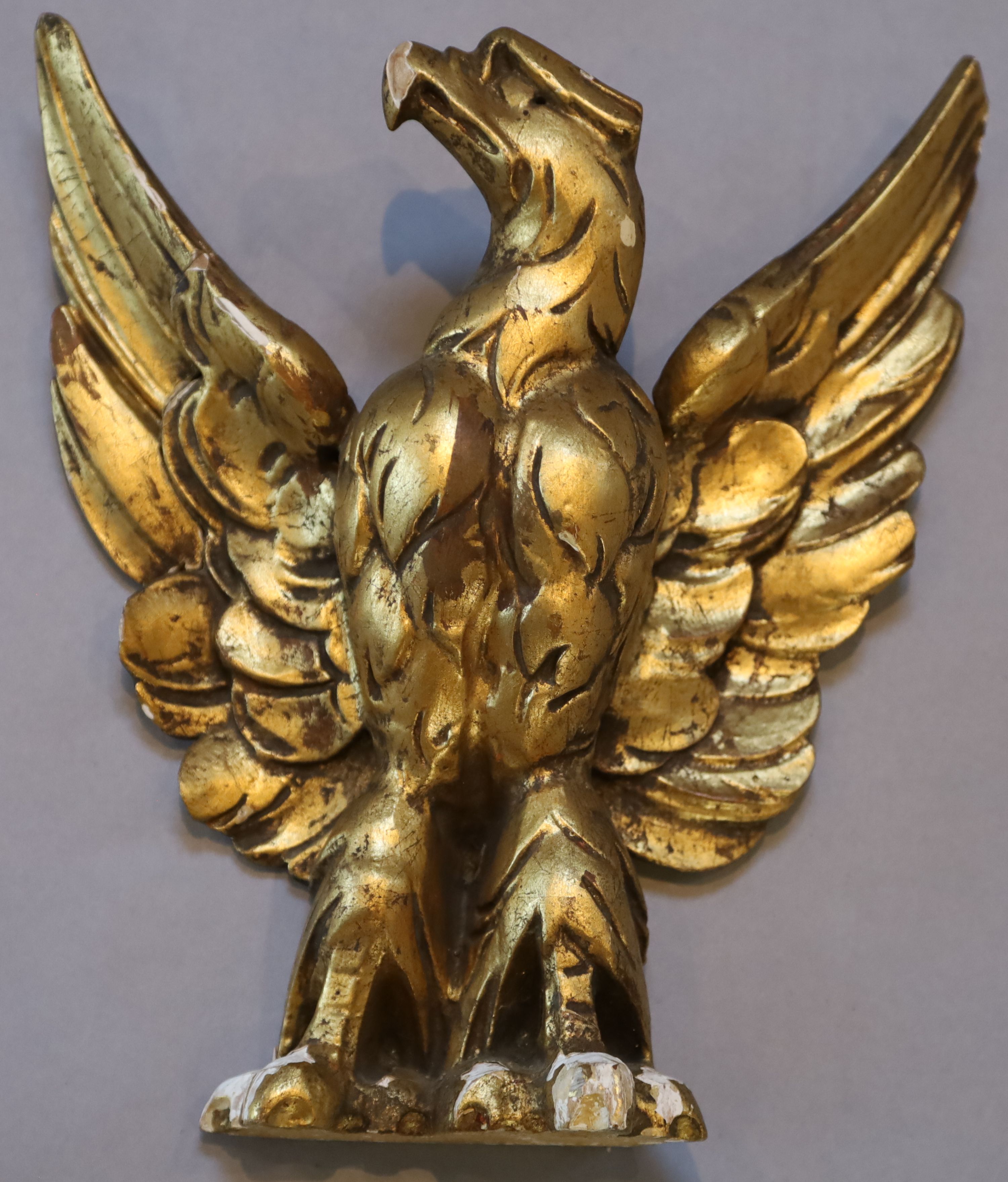 A set of three carved giltwood heraldic eagles, width 24cm height 26cm
